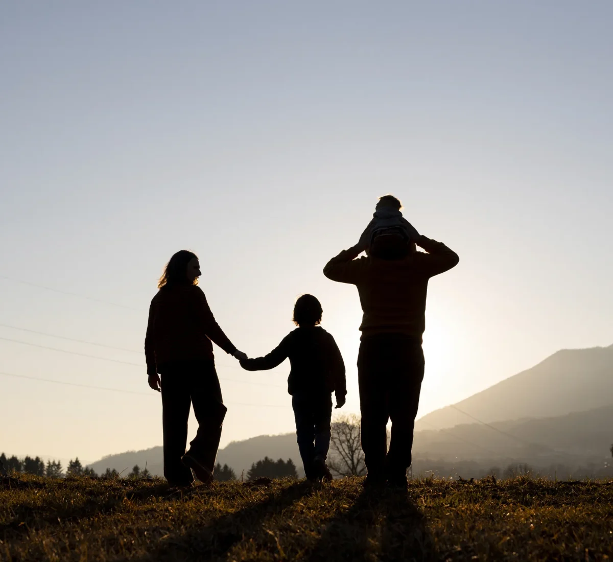 Family walking together at sunset