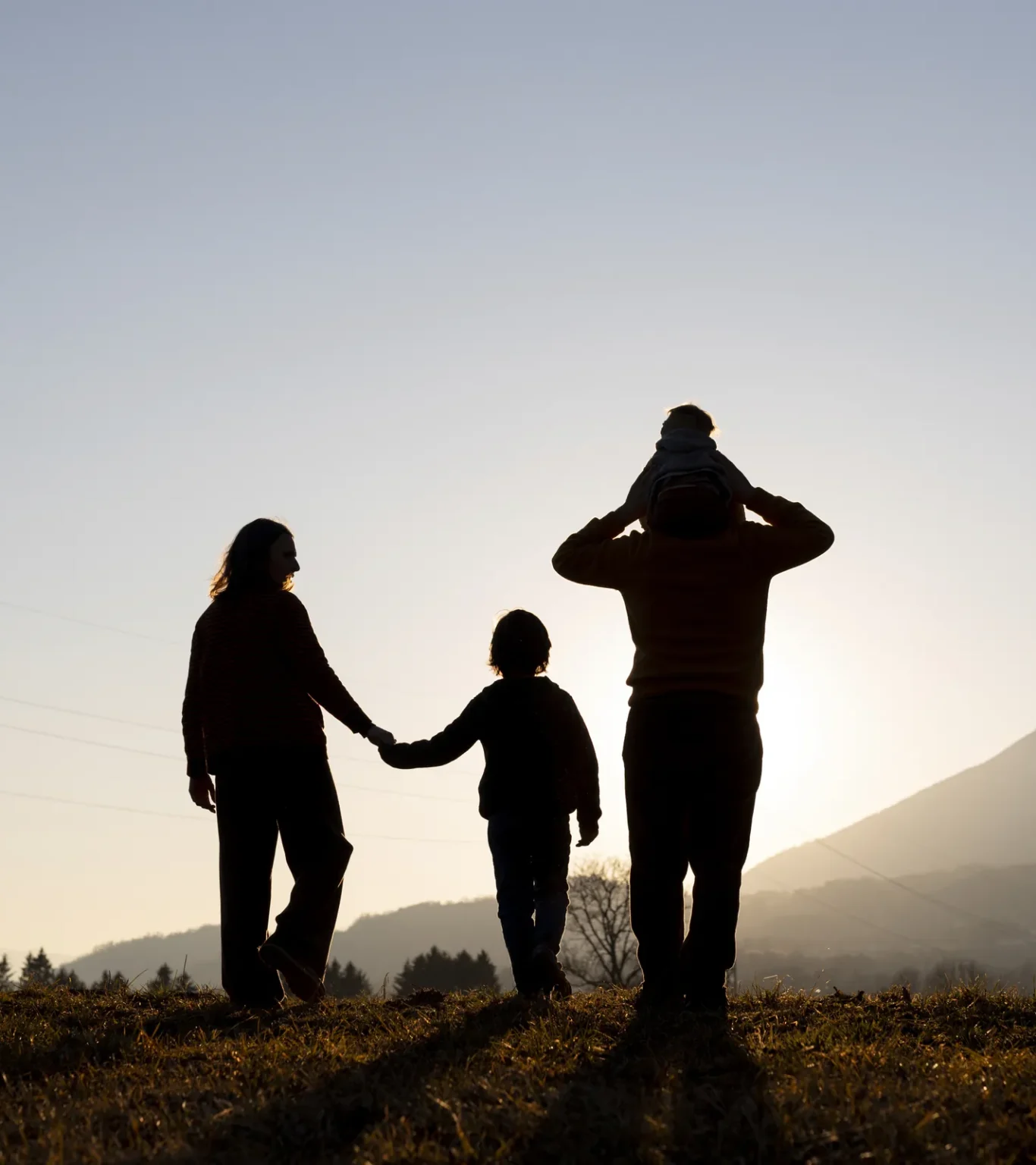 Family walking together at sunset