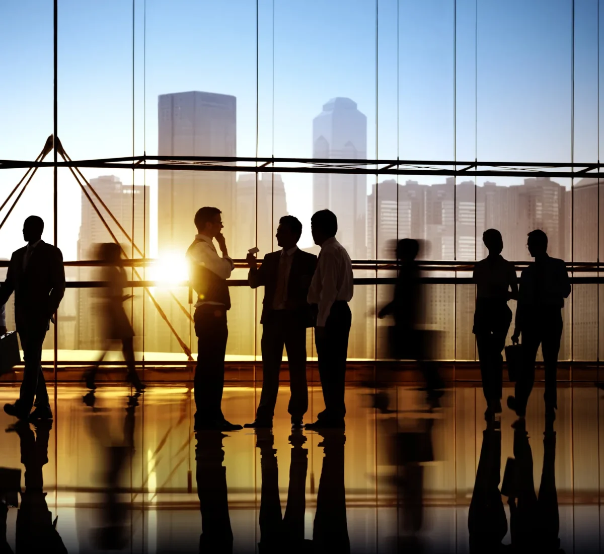 Professionals silhouetted against a city skyline